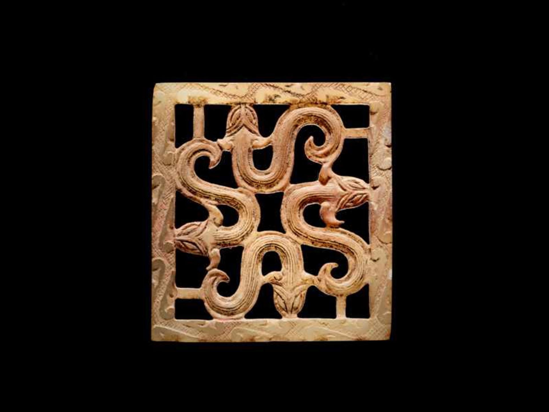 A SQUARE PLAQUE WITH AN OPENWORK PATTERN OF FOUR SNAKES Jade. China, Eastern Zhou, 5th - 4th century