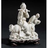 IMMORTAL PLAYING FLUTE Blanc de Chine porcelain. China, Dehua, RepublicHan Xiangzi sitting on a