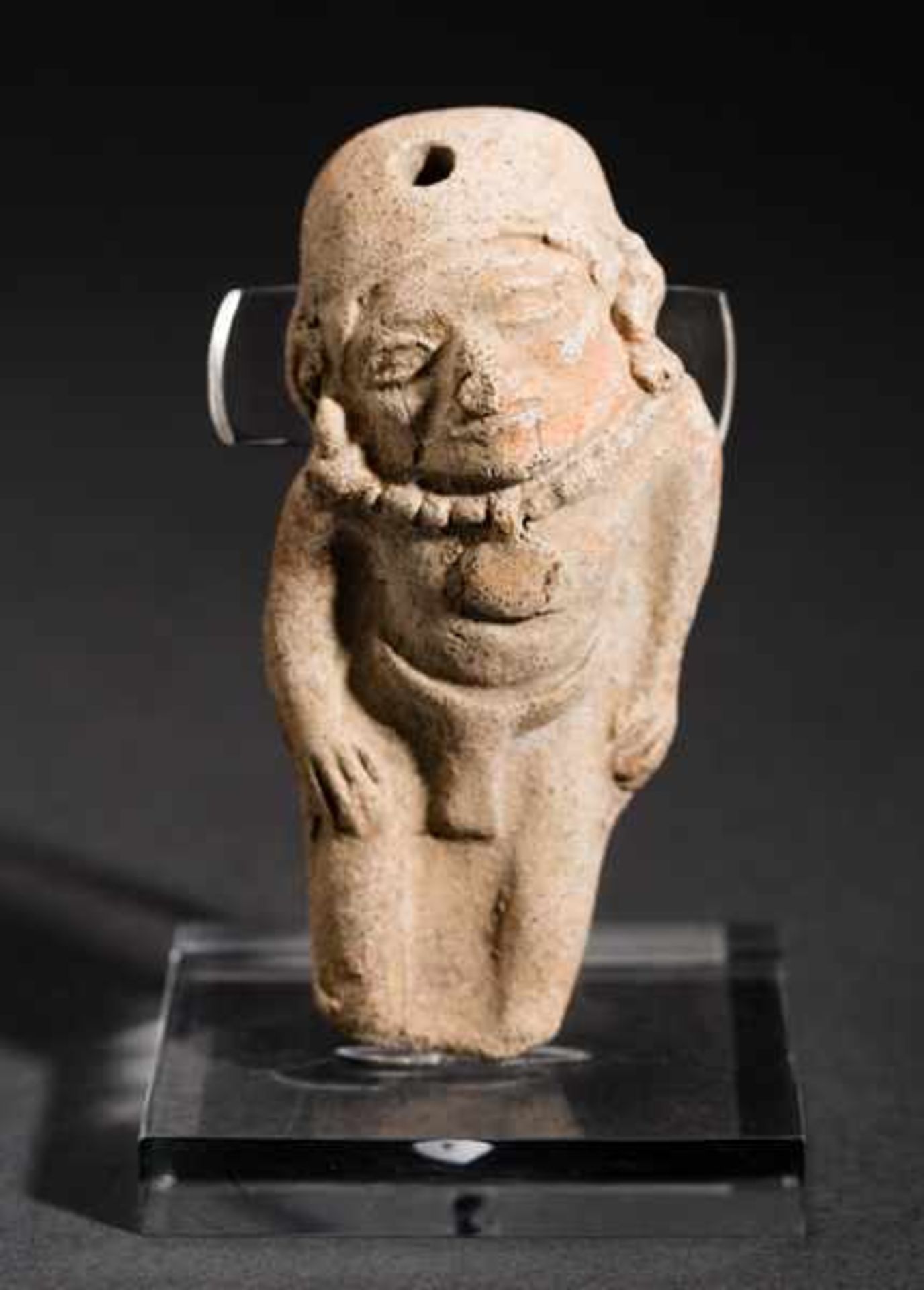 MALE AMULET-FIGURE Terracotta. La Tolita, ca. 200 ante to 200Largely formed facial features,