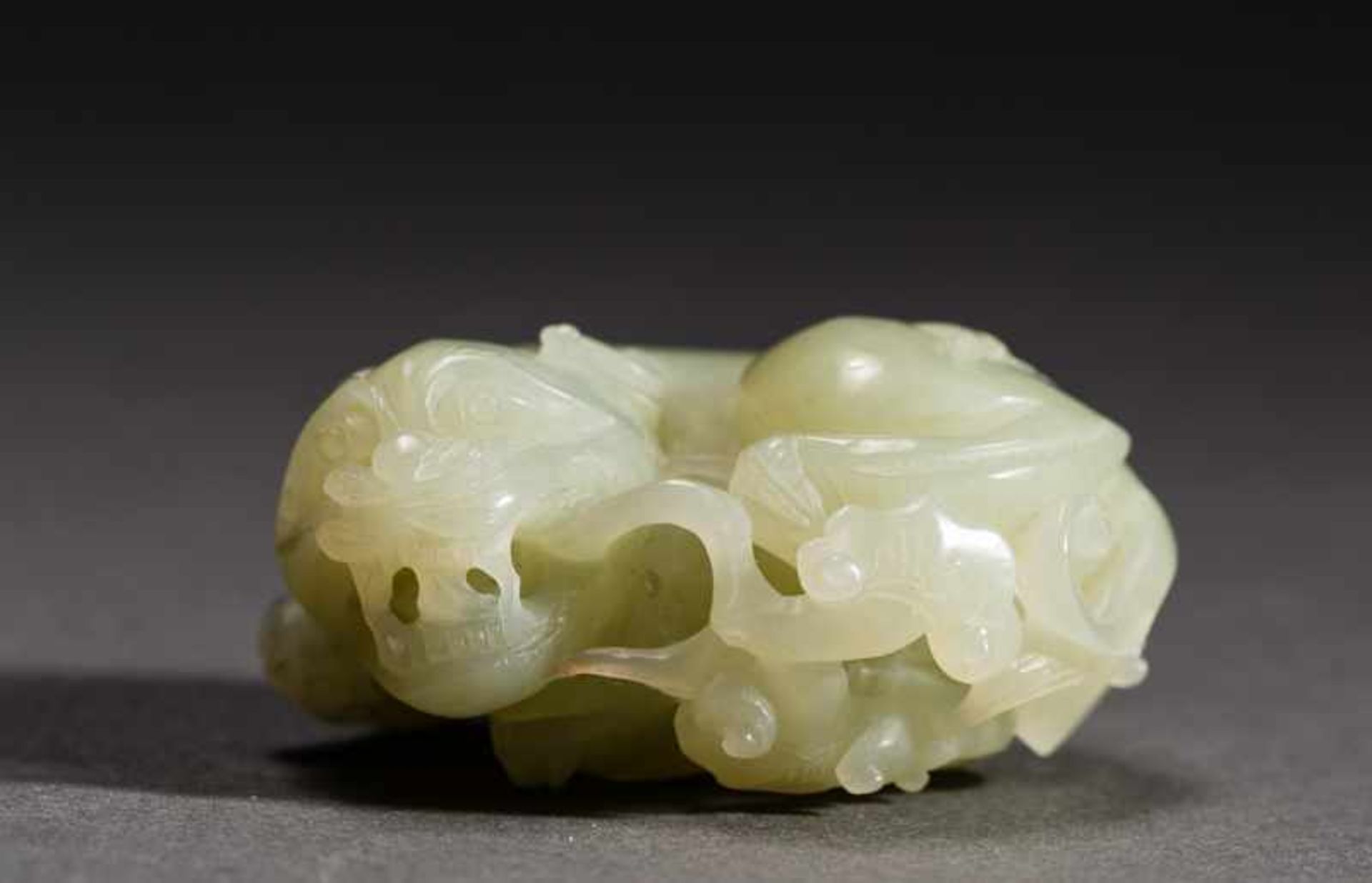 LYING SHIZI Jade. China, Round, lying lion-dog, shizi, with an expressively shaped head. Open mouth,