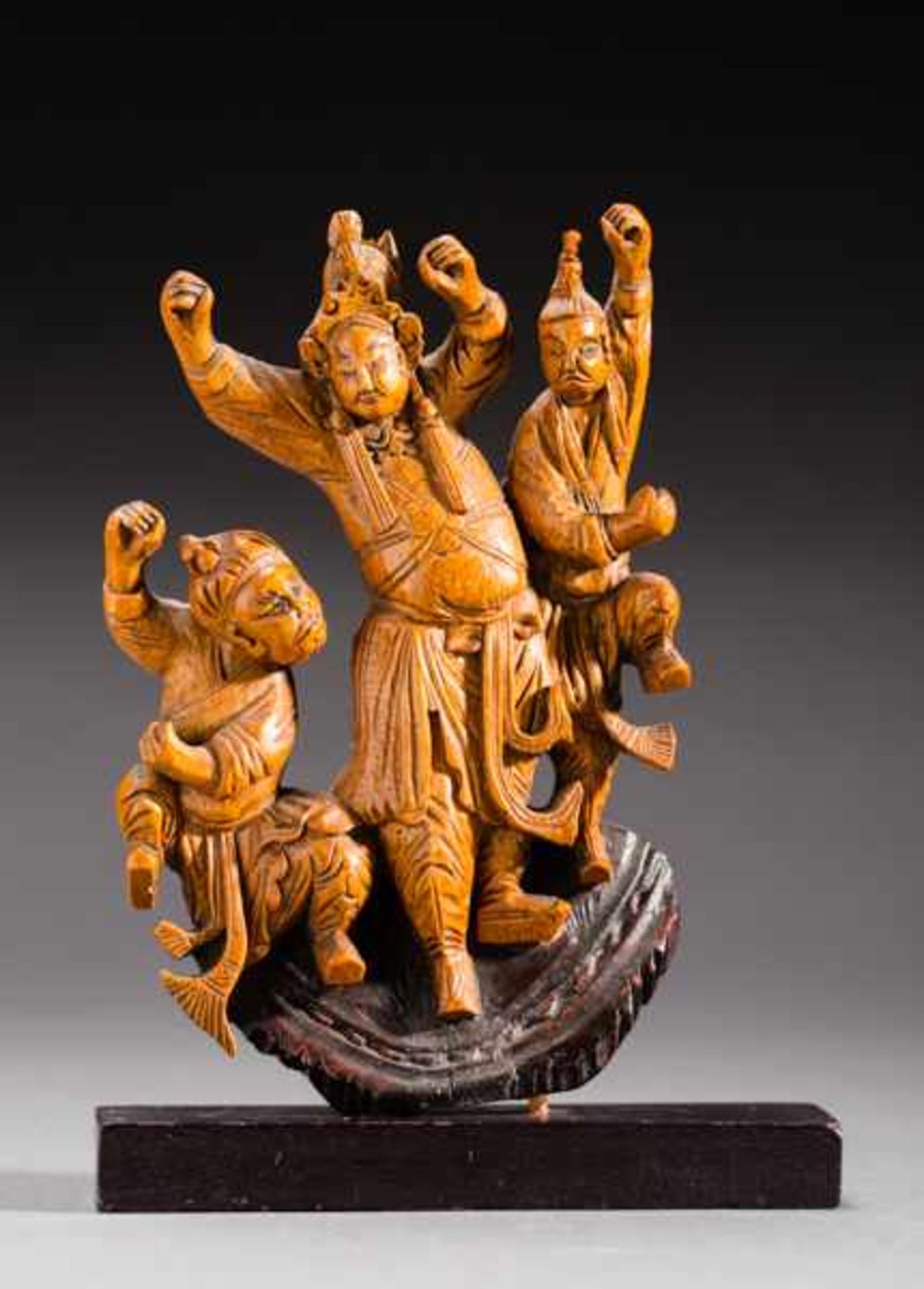 CHINESE THEATER SCENE Wood. China, 19th to early 20th cent.Three dancing figures, dressed in