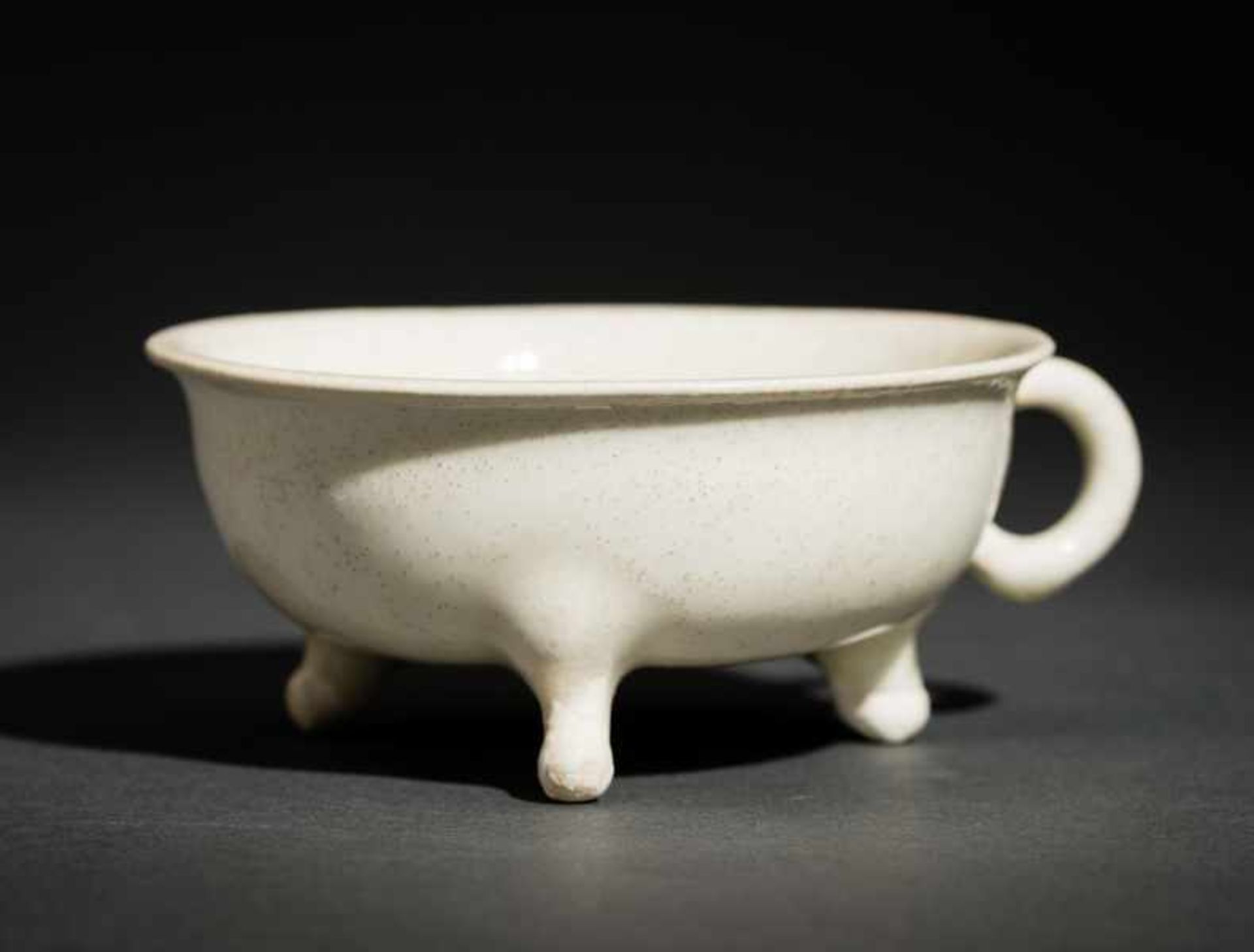 SMALL BOWL WITH HANDLE AND TRIPOD-FOOT Glazed ceramic. China, This bowl, standing on three outwardly