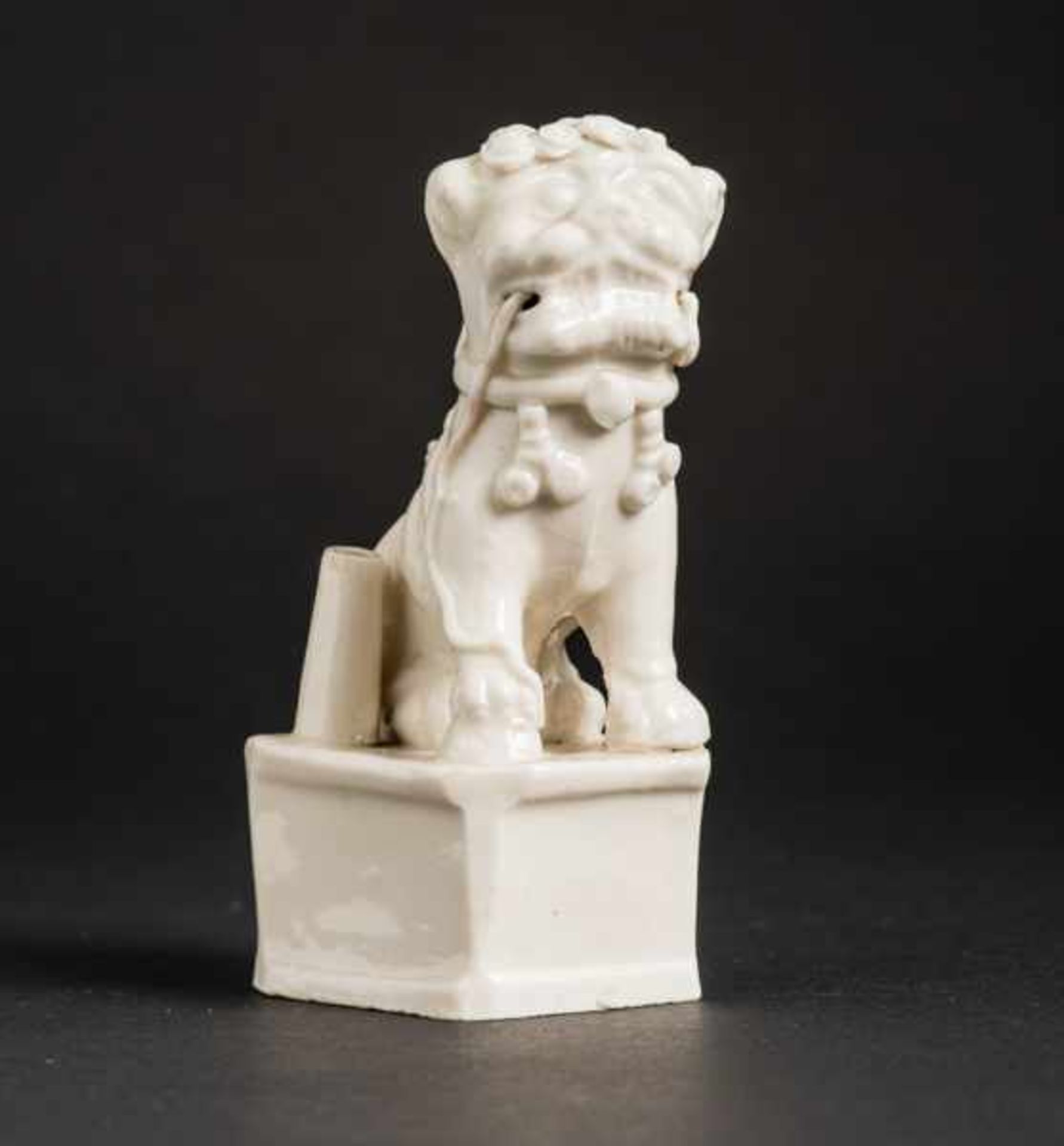 GUARDIAN LION (FO-LION) ON PEDESTAL Blanc de Chine porcelain. China, Qing dynasty (1644 -1911)