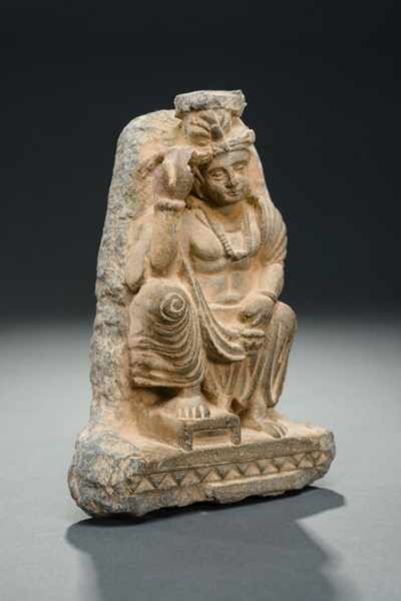 PART OF A FRIEZE DEPICTING SEATED BODHISATTVA Grey slate. Ghandara, ca. 2nd to 3rd cent. Figure of