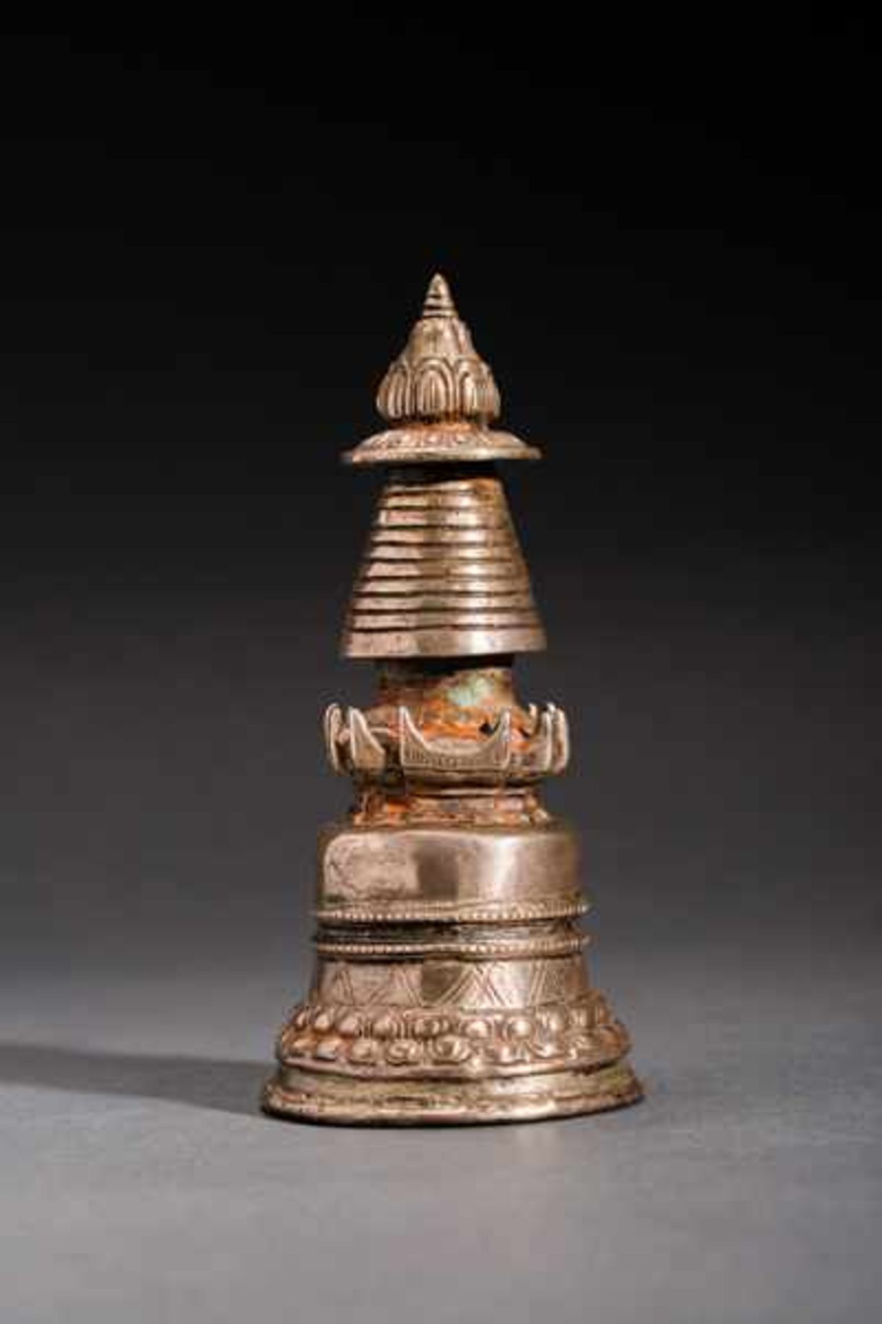 VOTIVE STUPA Silver-plated bronze. Tibet, 19th cent.On the whole, this handy chaitya has a conical
