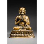 HOLY GURU Fire-gilded bronze. Tibet, late 17th to 18th cent.Expressively designed bronze figure of a