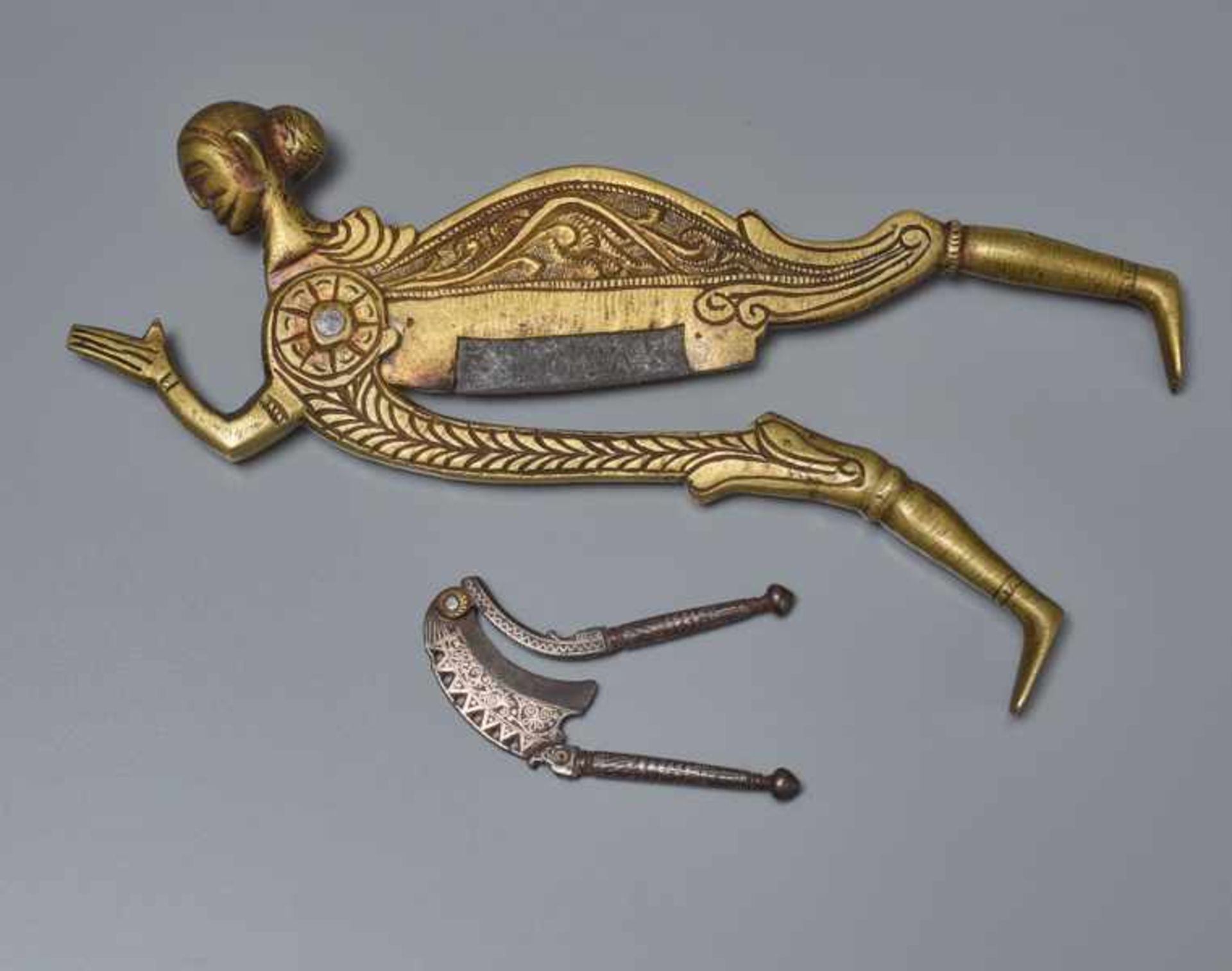 TWO BETEL NUTCRACKERS Brass and iron. Southern India, 19th cent.The first nutcracker is