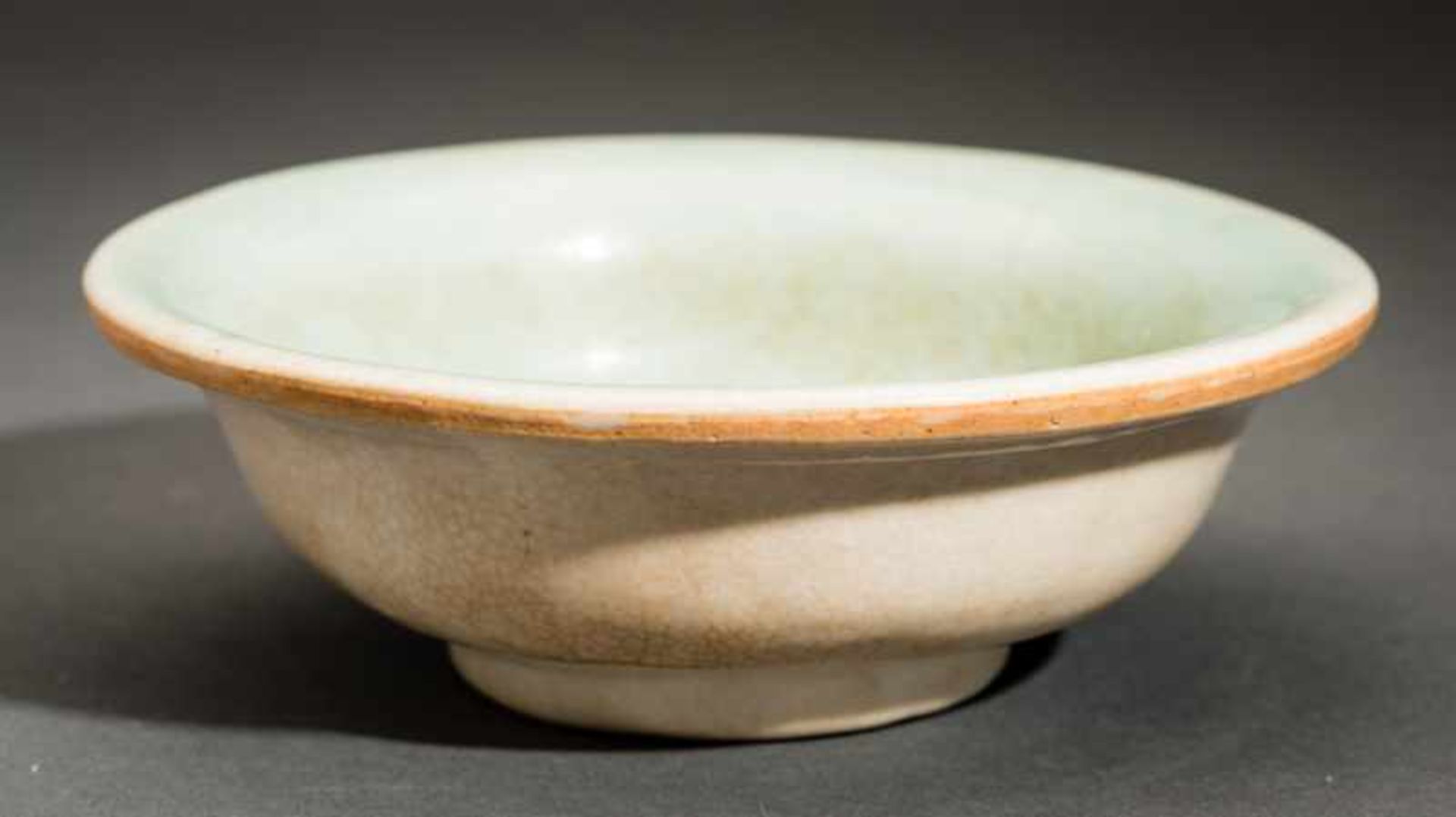 BOWL WITH CRAQUELURE Glazed ceramic. China, Yuan to MingSolidly built body with curved walls and