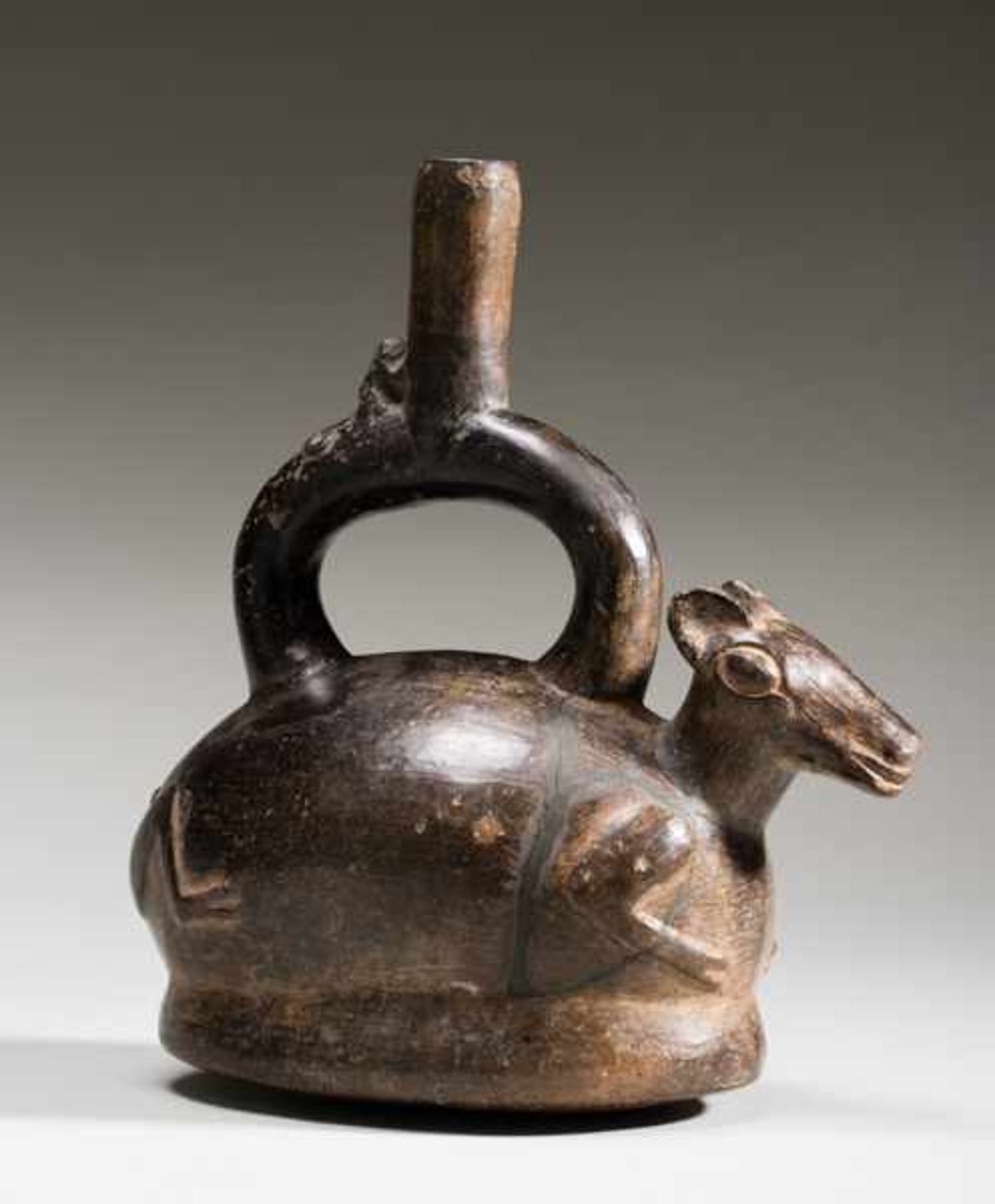 VESSEL IN THE SHAPE OF A LAMA Terracotta. Chimu, Peru, ca. 1000 - 1200This oval vessel has the shape