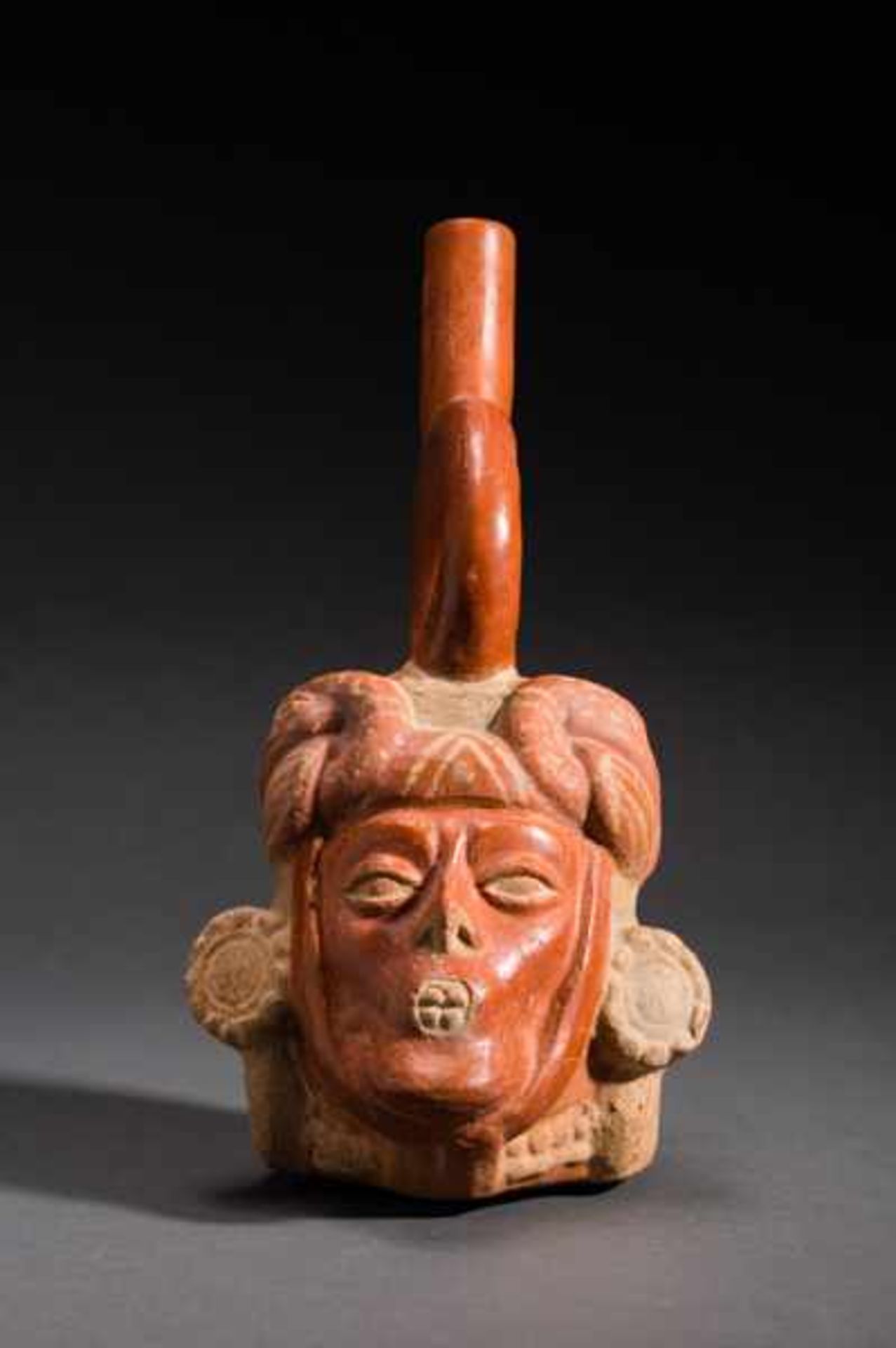 VESSEL IN THE SHAPE OF A DIGNITARY’S HEAD Terracotta. Moche, ca. 7th cent. (TL-tested)This vessel