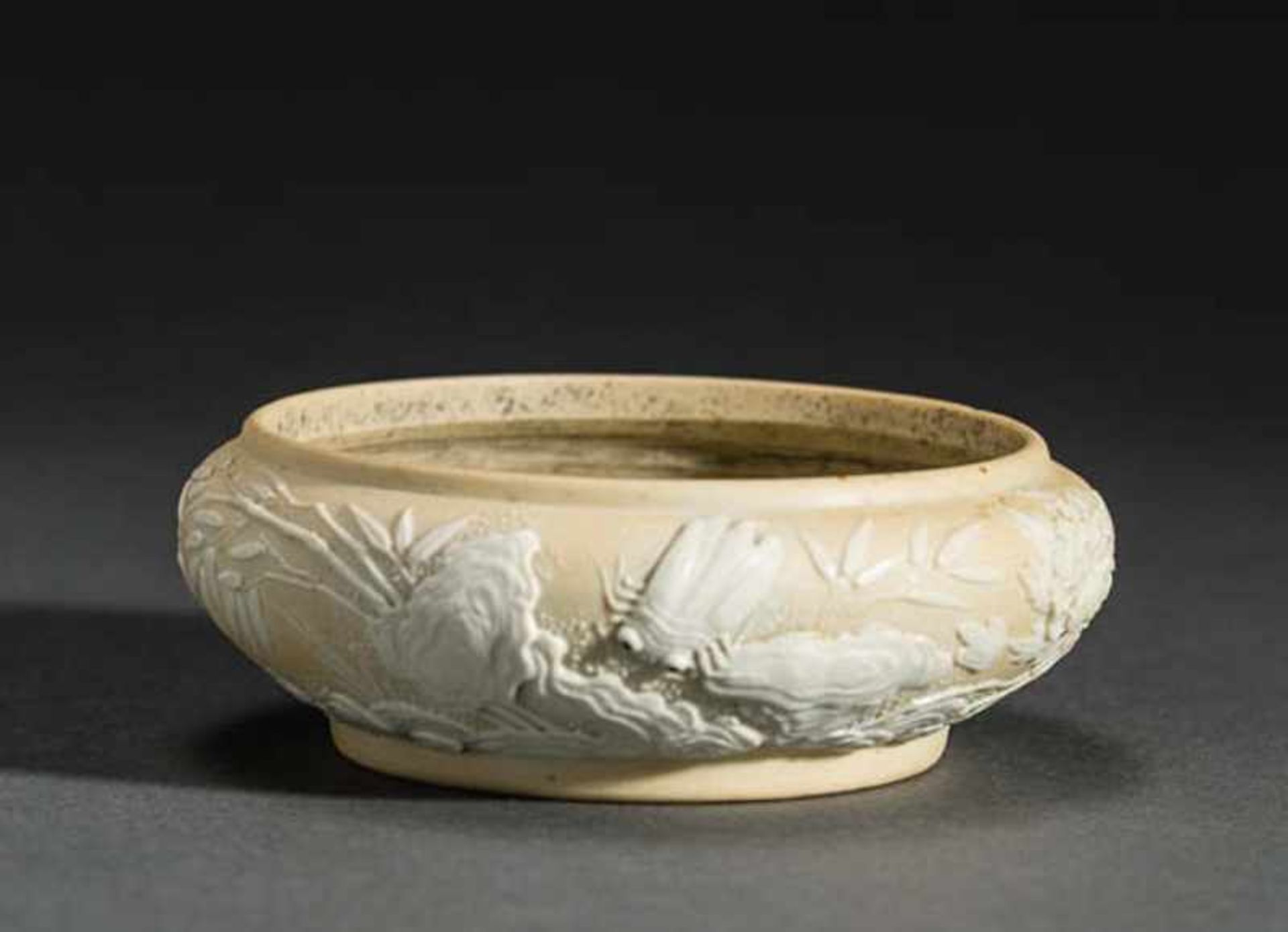 BOWL FEATURING BLOSSOMS, BEETLES, FISH Unglazed porcelain with fused decoration. China, Qing dynasty
