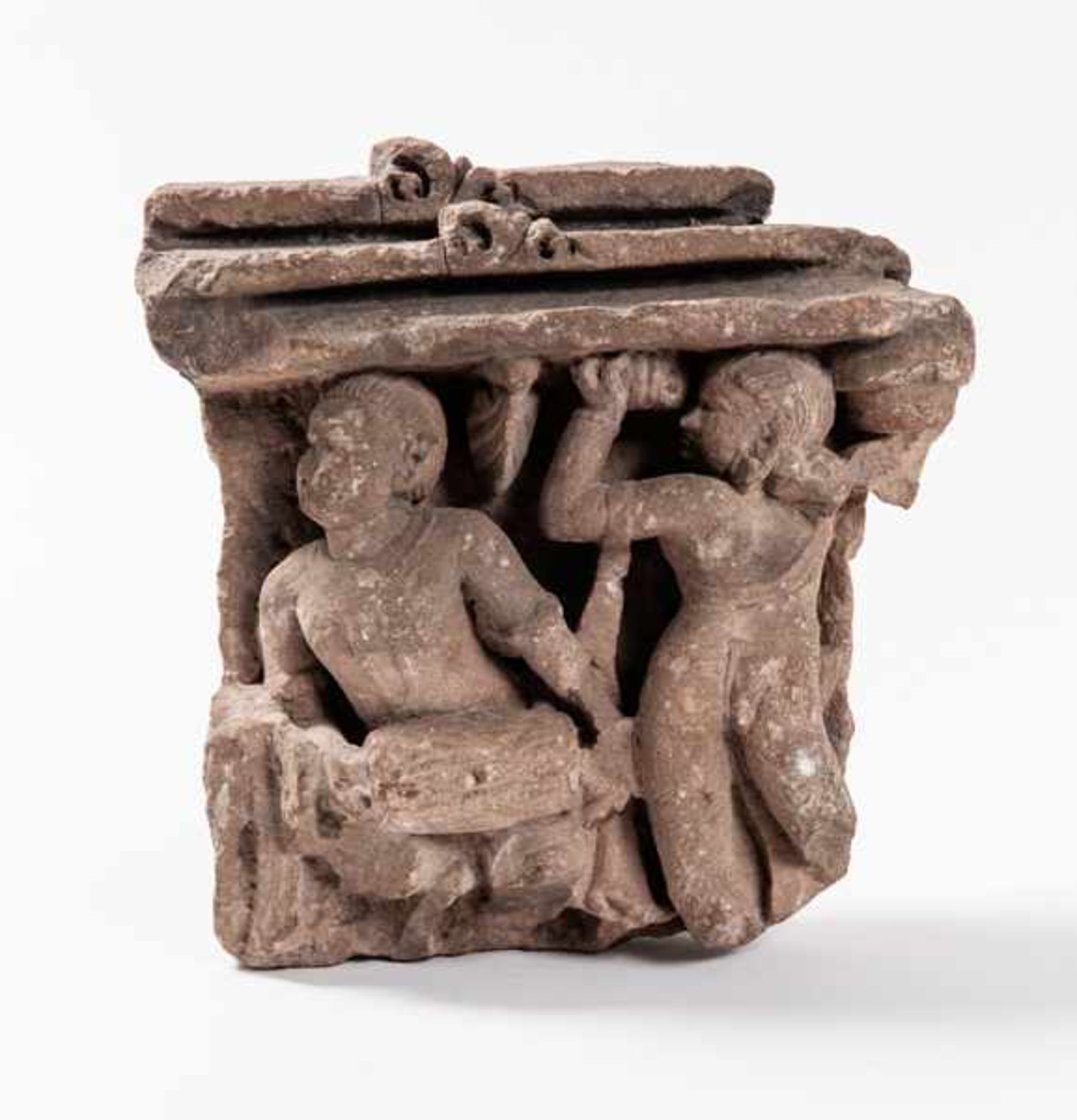 A FRAGMENT OF AN INDIAN STELE WITH A DRUMMER AND A DANCER Sandstone. India, ca. 12th-14th cent.