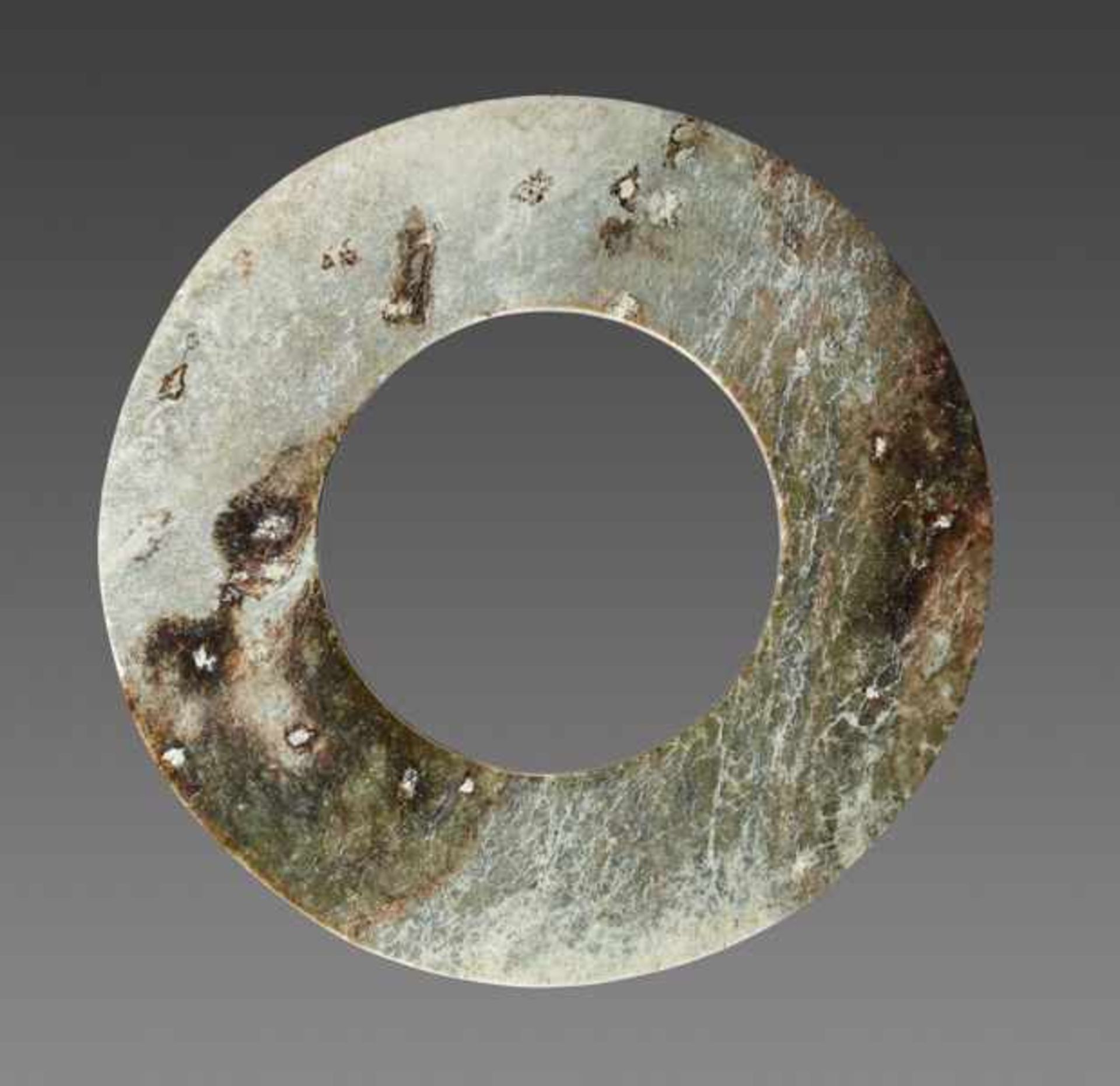 DISC YUAN Jade. China, late Neolithic to early Bronze Age, ca. 2000 - 1600 BCBoth sides of this