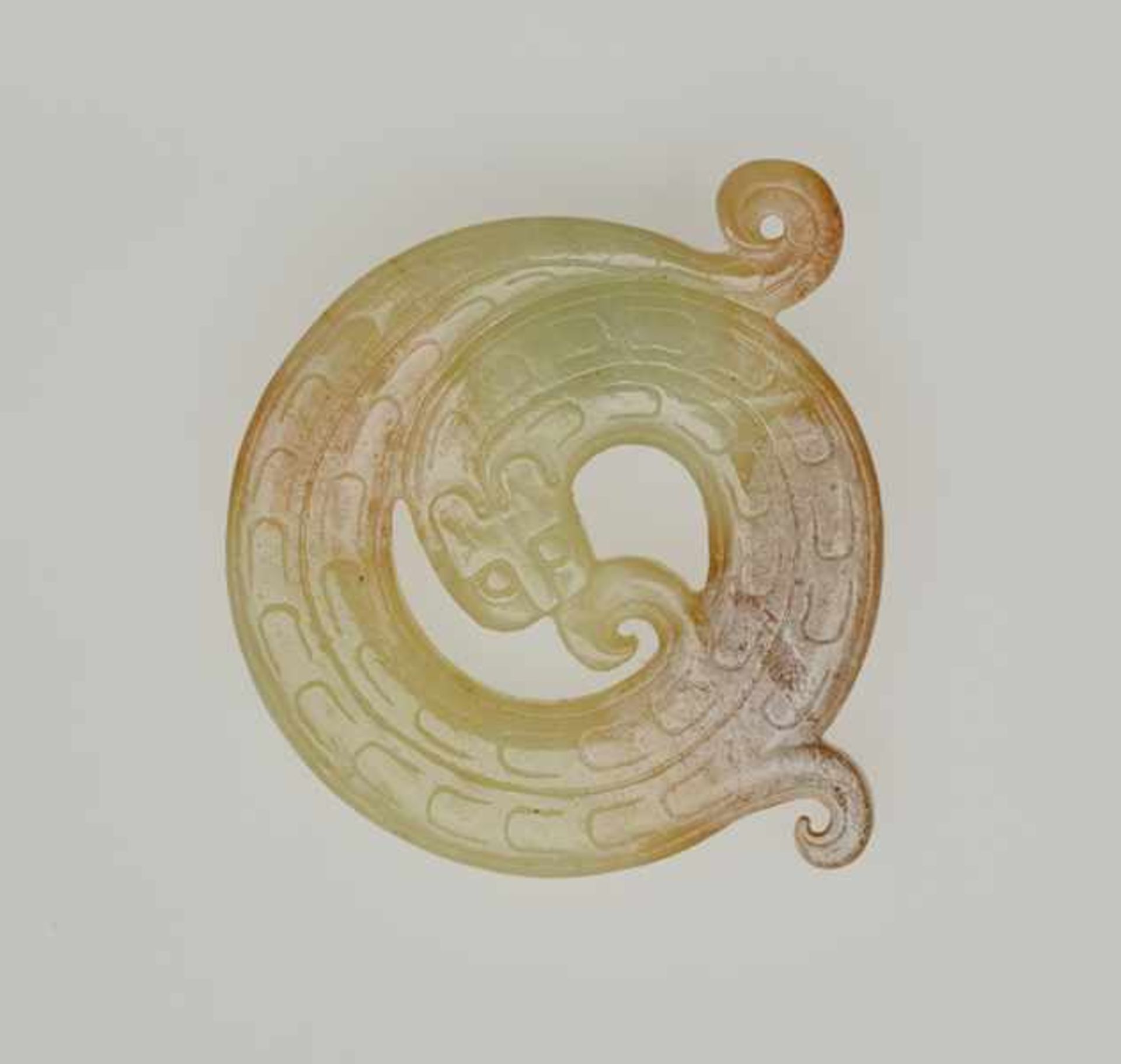 CURLED-UP CHILONG Jade. China, Eastern Zhou, 5th - 4th century BCThis very fine and delicately