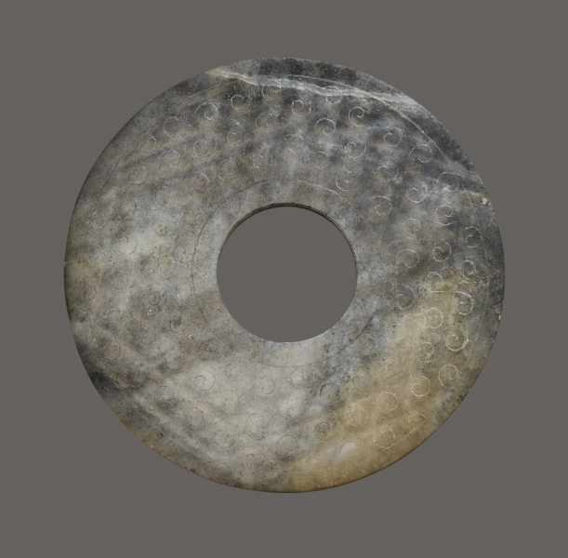 BI WITH SPIRAL CLOUDS DECORATION Jade. China, Han dynasty, 206 BC - 220 CEWhite-gray to black