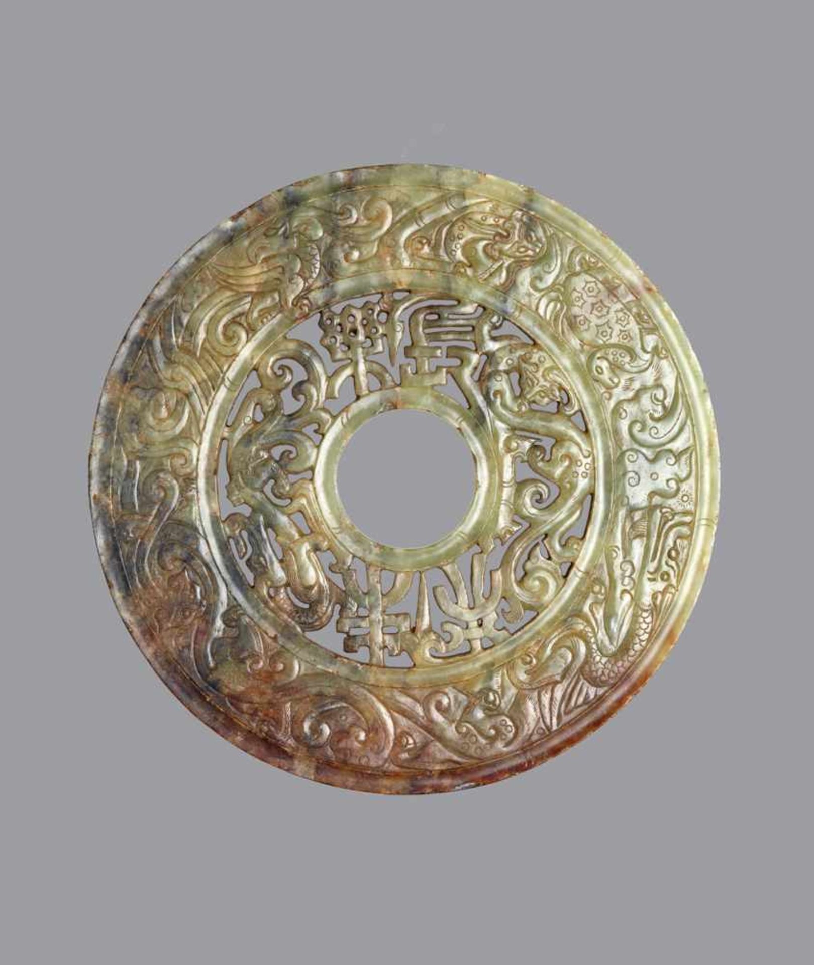 BI-DISC WITH DRAGONS, ANIMALS AND CHINESE CHARACTERS Jade. China, Eastern Han, 25-220 ADA