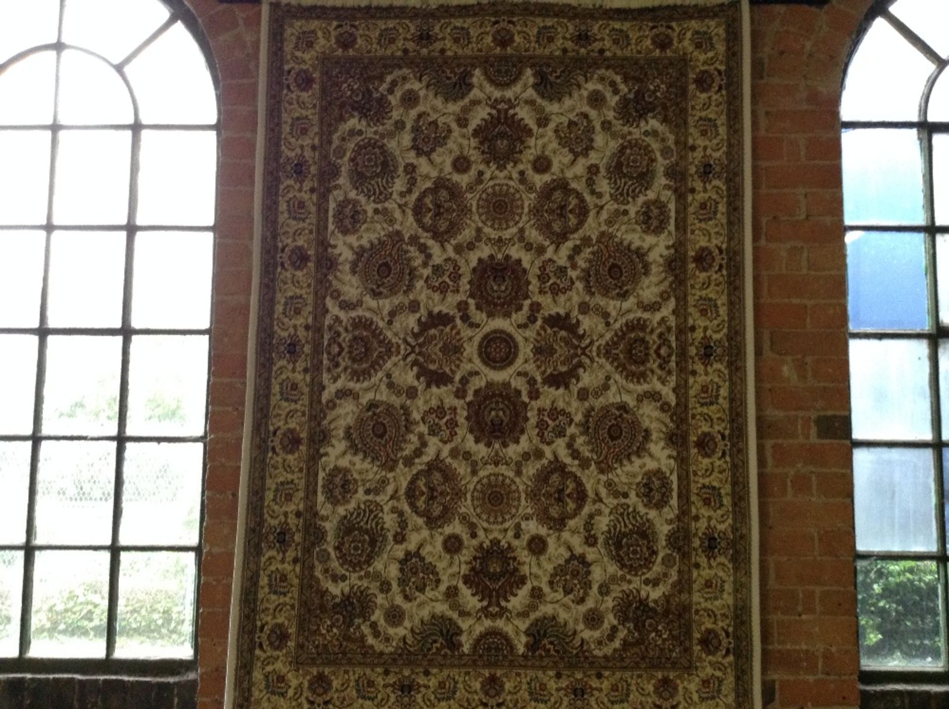 IVORY GROUND WOVEN SILK RUG WITH ALL OVER FLORAL D