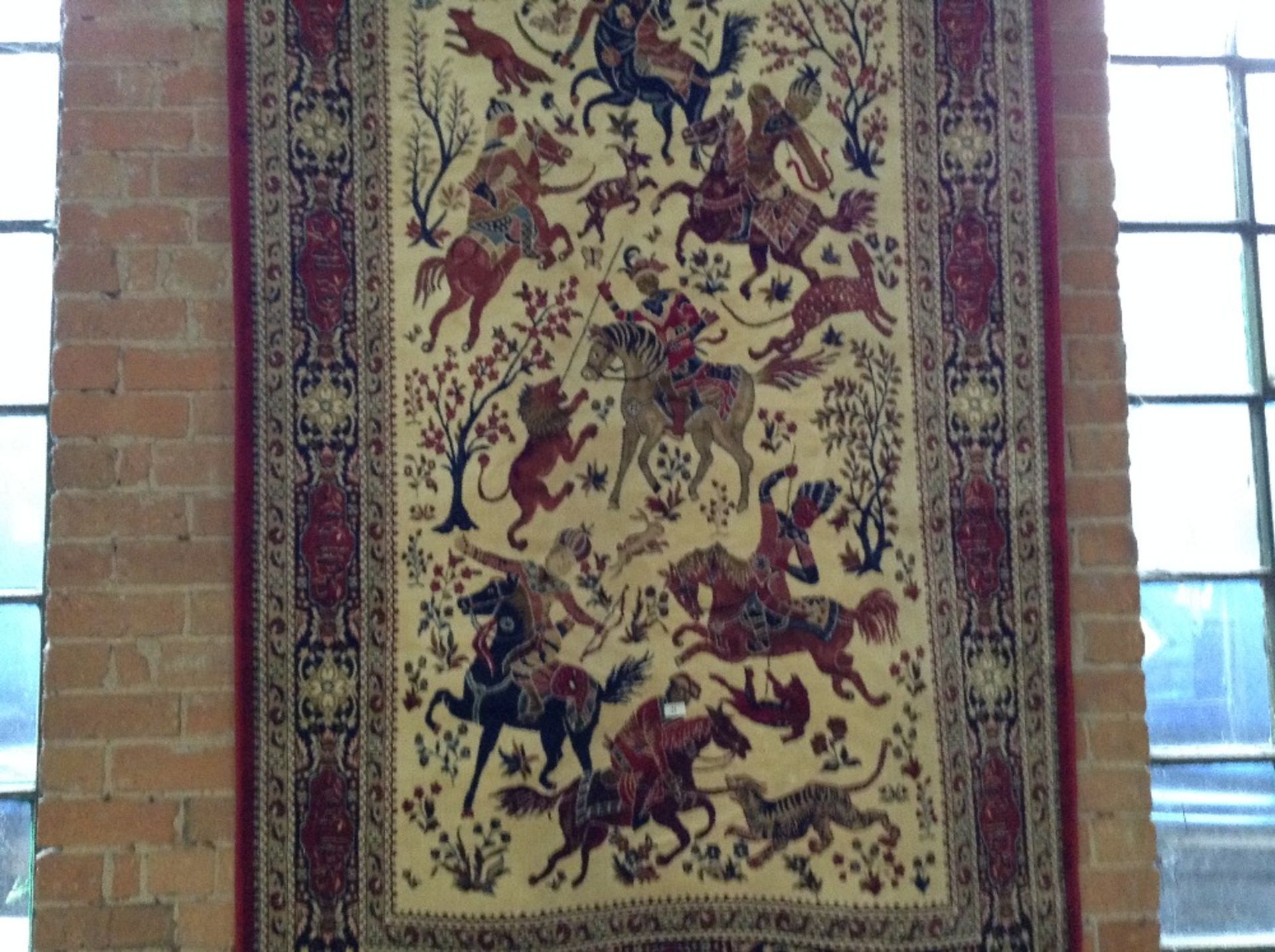 RED GROUND KASHMIR RUG WITH A HUNTING SCENE – 2.3M