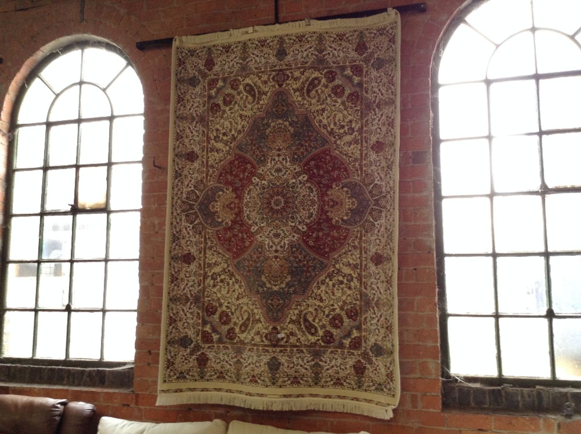 IVORY GROUND WOVEN SILK RUG WITH A UNIQUE MEDALLIO