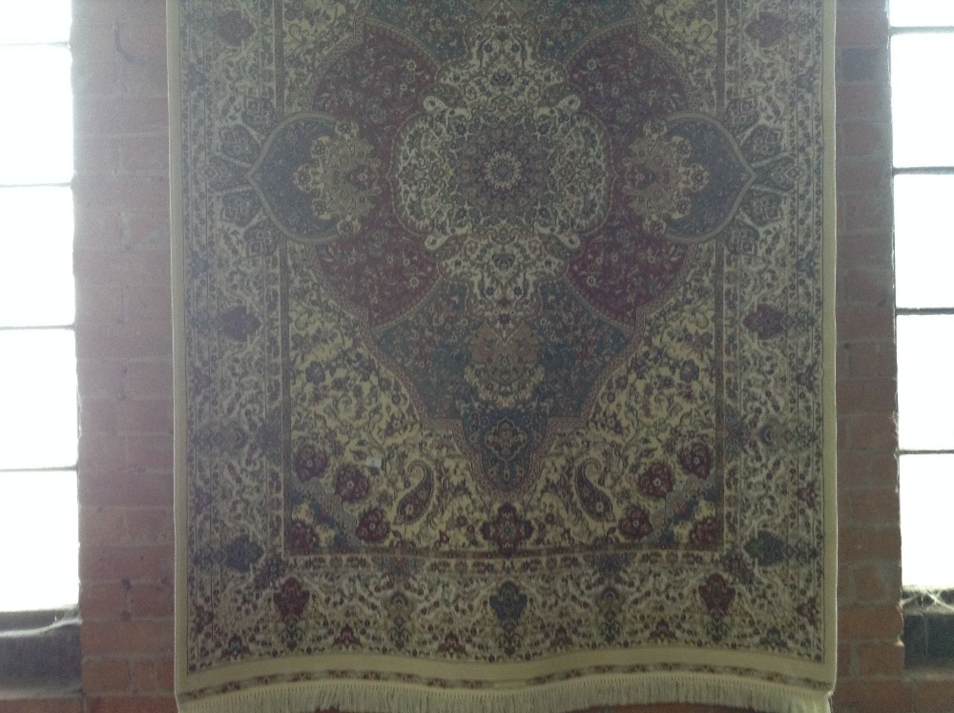 IVORY GROUND WOVEN SILK RUG WITH A UNIQUE MEDALLIO