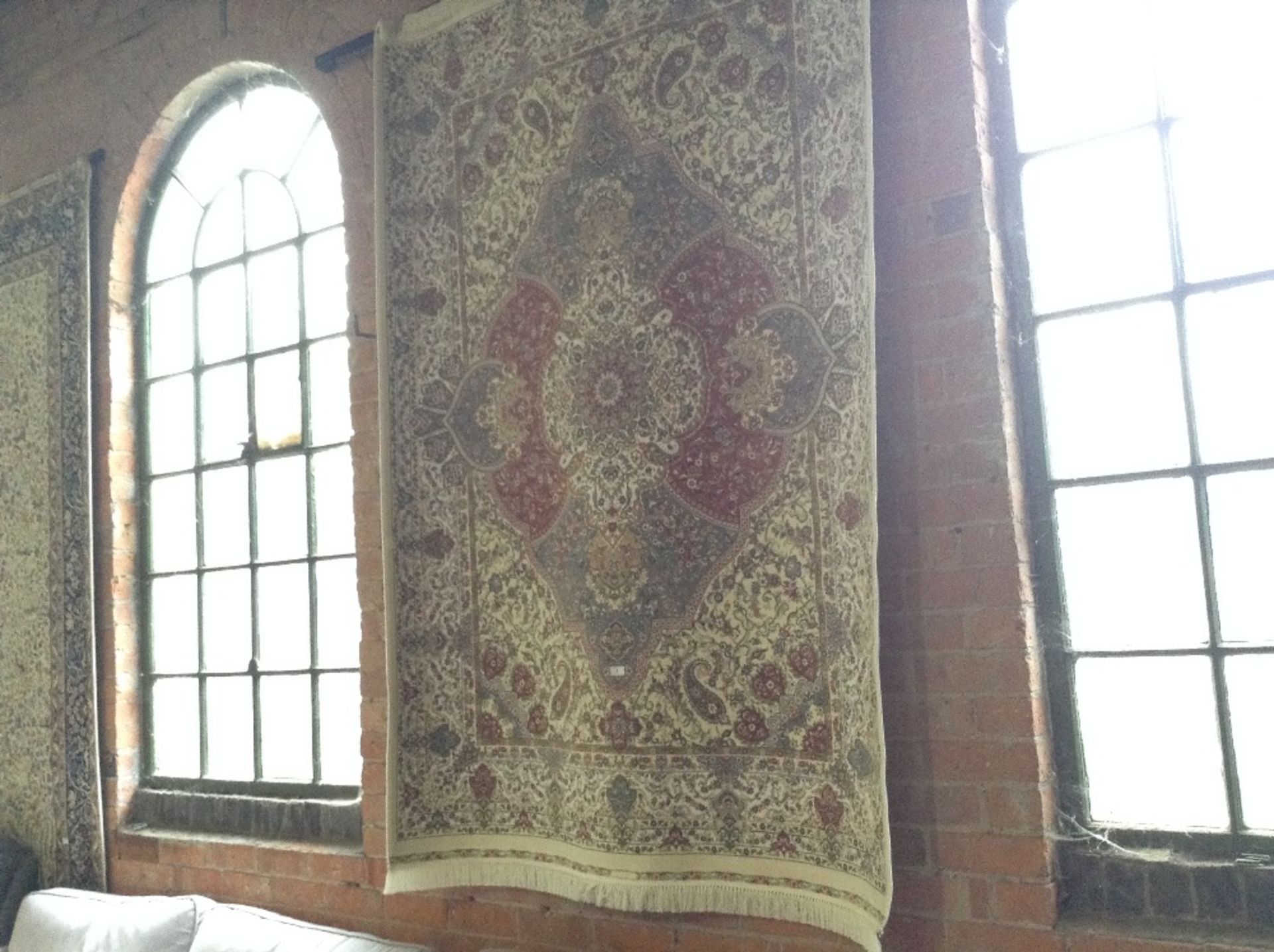 IVORY GROUND WOVEN SILK RUG WITH A UNIQUE MEDALLIO