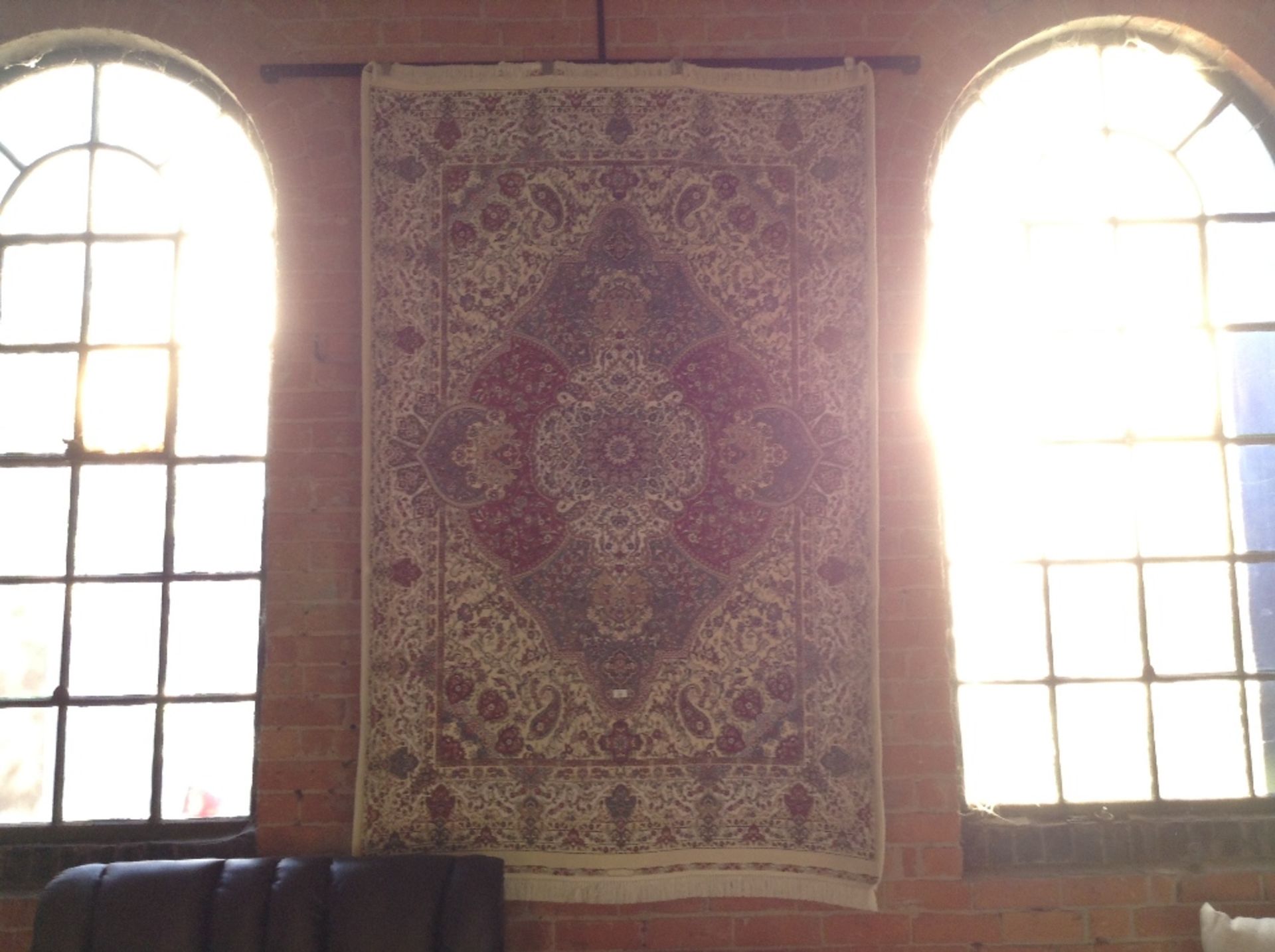 IVORY GROUND WOVEN SILK RUG WITH A UNIQUE MEDALLIO