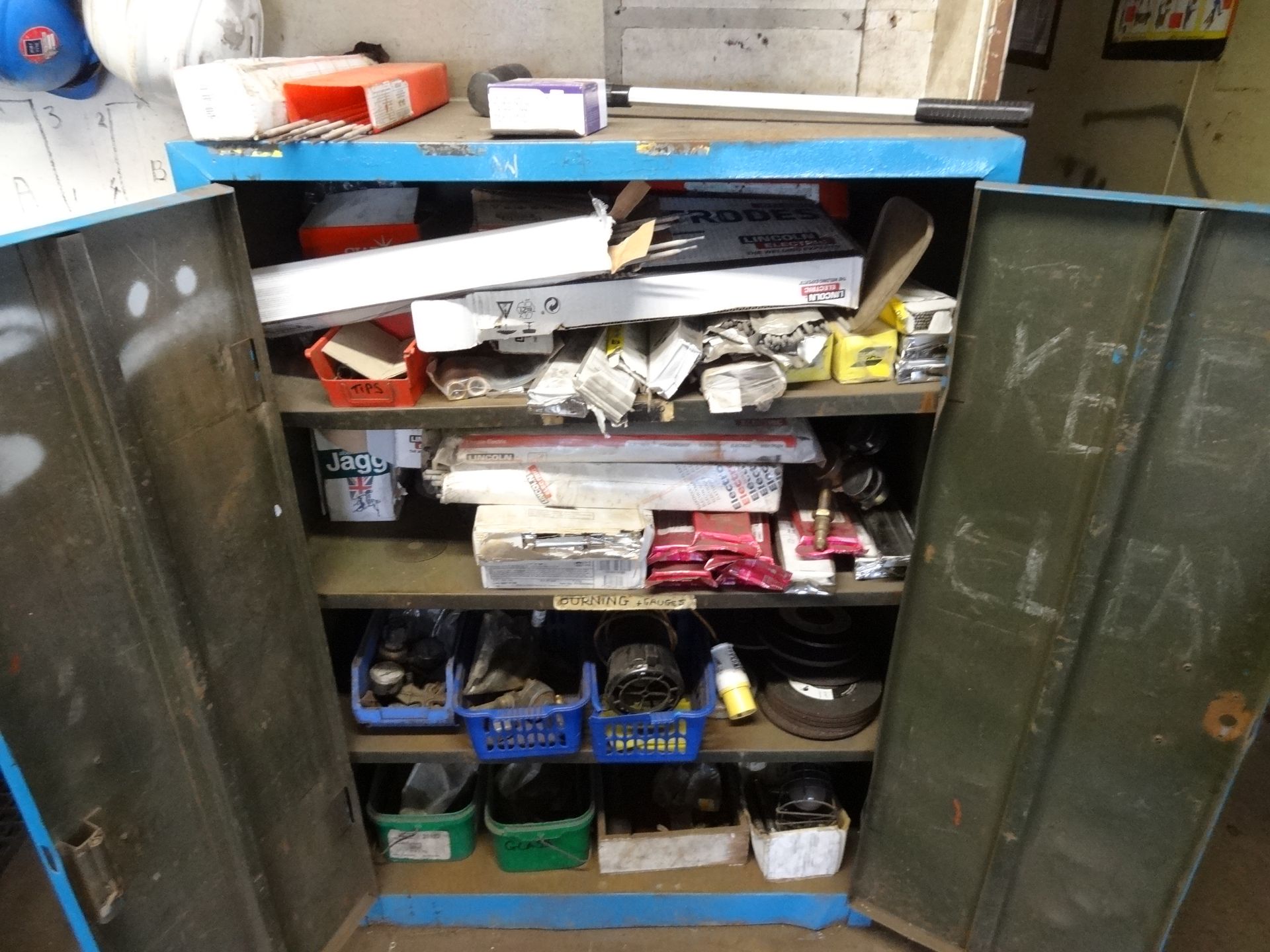 Large quantity of welding consumables in double door steel cupboard and under bench (Lift out charge - Image 2 of 3