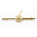 A cased 15ct. gold bar brooch, set with eight seed pearls around a green stone, 4.