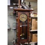 A 19th Century Vienna eight day wall clock, with an enamelled chapter dial and black Roman numerals,