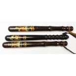 Three Victorian painted wood truncheon, painted in gold and scarlet with a Crown, 39cm.