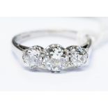 A diamond three stone 18k white gold ring,