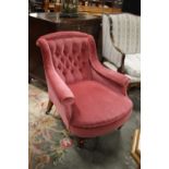 A late Victorian armchair, upholstered in pink,