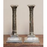 A pair of Victorian silver Corinthian column candlesticks, square bases 24 cm high,