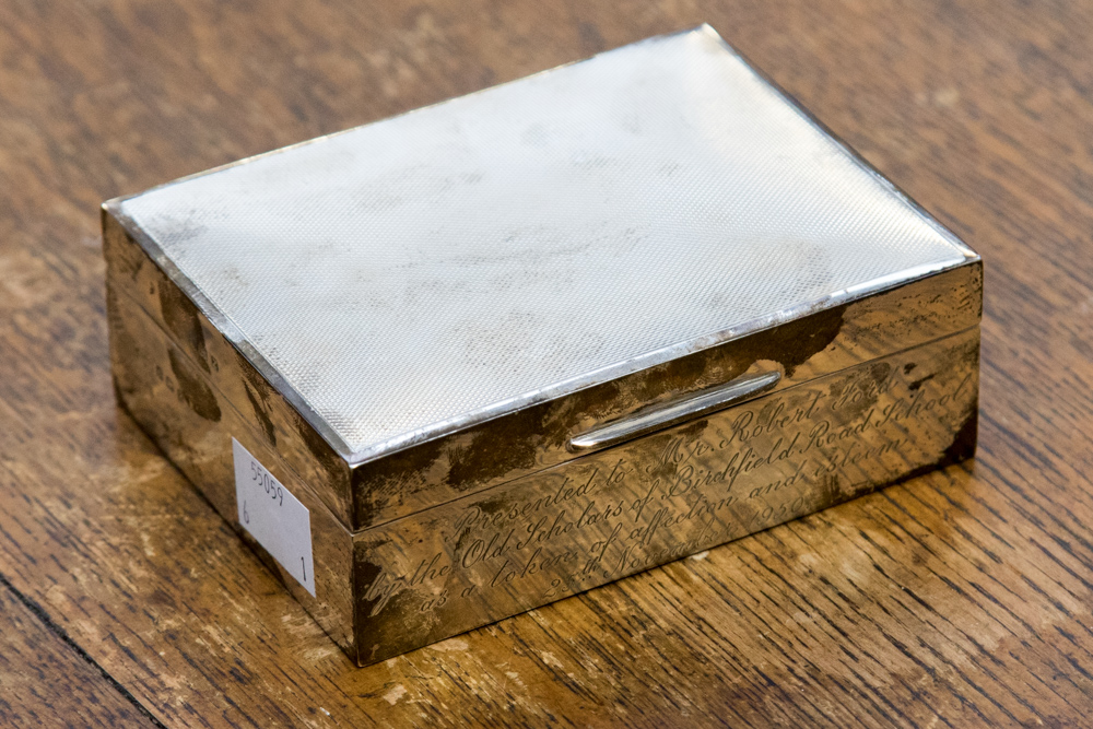 A George VI silver cigarette box, engine turned decoration to top,