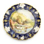 A Royal Crown Derby painted plate with a scene of Monsal Dale Derbyshire, vine moulded border,