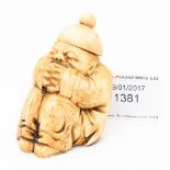 A Chinese carved ivory snuff bottle, in the form of a squatting mandarin,