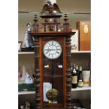 A 19th Century walnut Vienna wall clock, eight day, having a white enamelled dial,