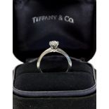 A Tiffany & Co diamond solitaire platinum ring, the round brilliant cut diamond weighing 0.