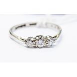 An 18ct white gold and platinum three stone diamond ring, total diamond weight approx 0.