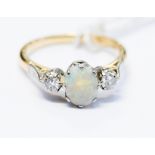 An opal and diamond three stone 18ct yellow gold ring, the centre opal cabachon approx 8 x 6mm,