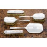 An Art Deco silver dressing table brush set, comprising two hairbrushes,