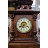 An Edwardian veneered mantel clock,