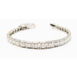 A graduated diamond bracelet comprising thirty three square section links,