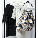 A satin mix black and white mini skirt with a yellow flower design late 1960s and a white applique