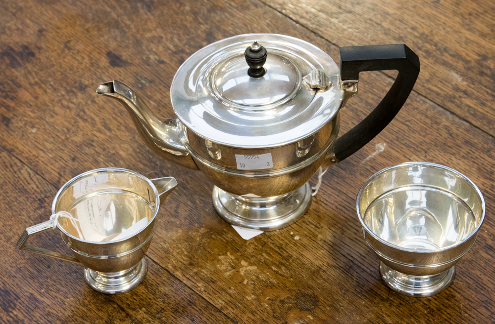 An Art Deco silver three-piece tea set, comprising teapot, milk and sugar,