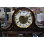 An early 20th Century oak Napoleon hat mantel clock