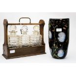 A Studio glass vase, black ground with water lillies, with a tantalus,