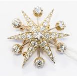 An Edwardian diamond star burst pendant/brooch, having an old cut diamond of approximately 0.