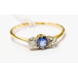 A sapphire and diamond three stone 18ct gold ring, size T, 2.