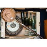 A wall mounted barometer with assorted ale and pop bottles,